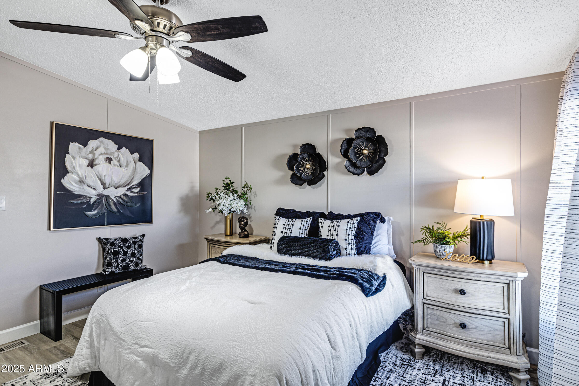 834 South Meridian Road, Unit 81 Apache Junction, AZ 85120 - Photo 10 of 22 a bedroom with a bed and a chandelier