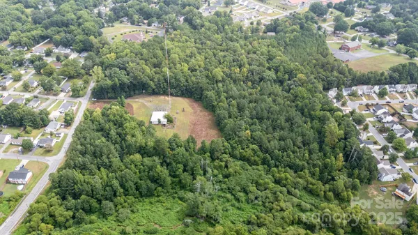 an aerial view of a house with a yard and outdoor seating