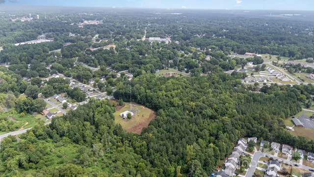 an aerial view of a house with yard