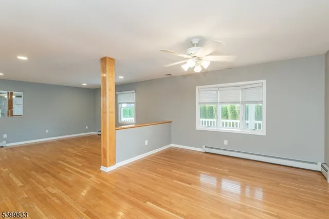 a view of large hall with stainless steel appliances granite countertop cabinets and fireplace
