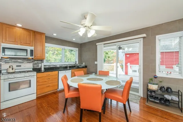 a dining room with furniture a chandelier and wooden floor