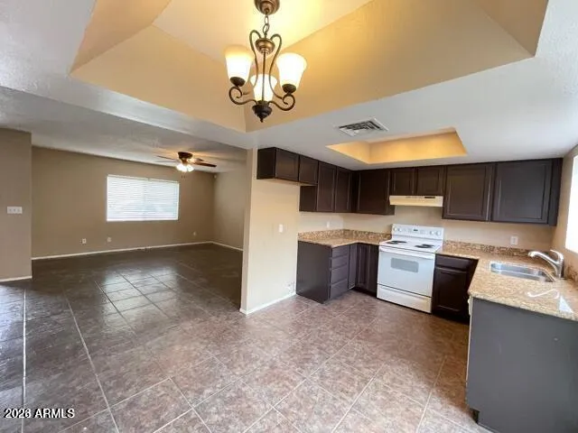 a view of a kitchen with a sink stainless steel appliances cabinets and a counter top space
