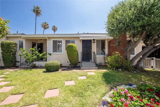 a view of a house with a yard and plants