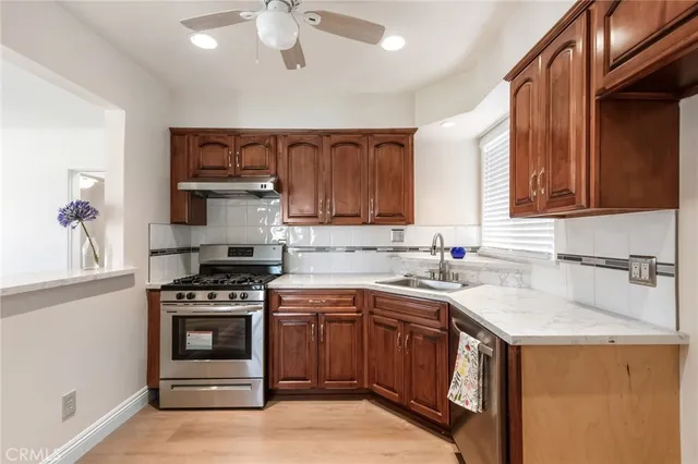 a kitchen with a stove sink and cabinets