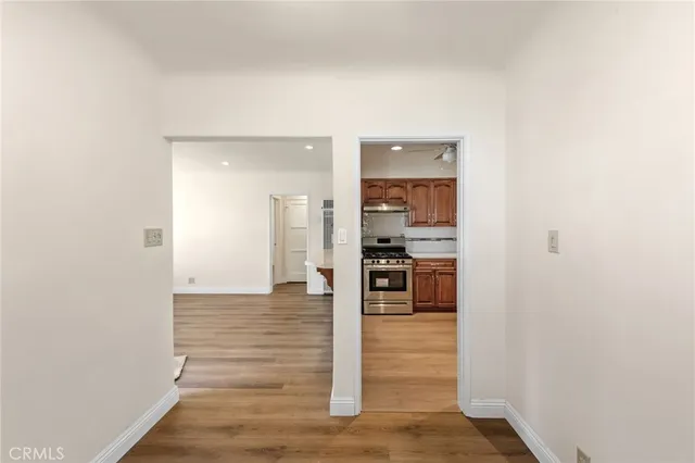 a view of kitchen and hall with wooden floor
