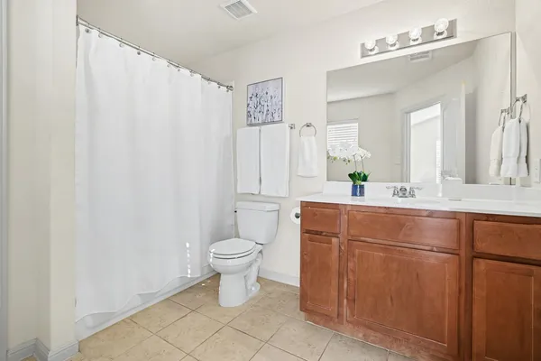 a bathroom with a sink a toilet and mirror