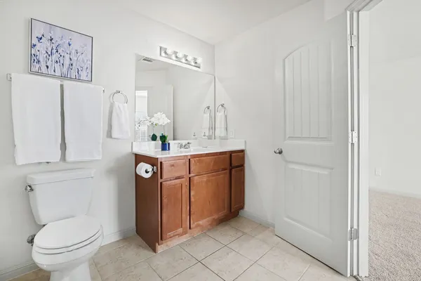 a bathroom with a sink a toilet and mirror