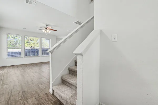 a view of entryway and hall with wooden floor