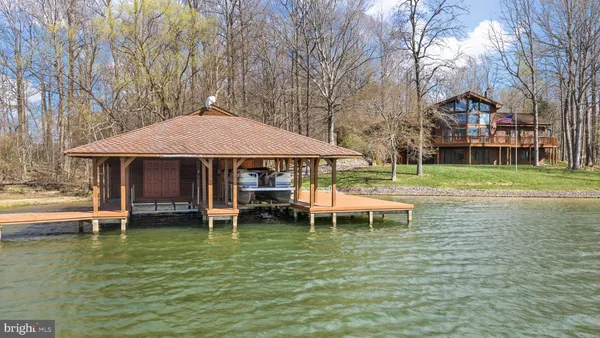 a view of a swimming pool with lawn chairs under an umbrella