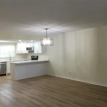a large kitchen with a white wooden cabinets