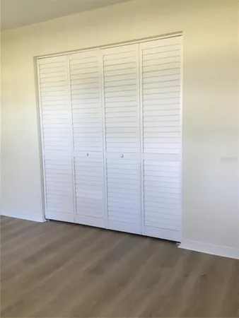 an empty room with wooden floor