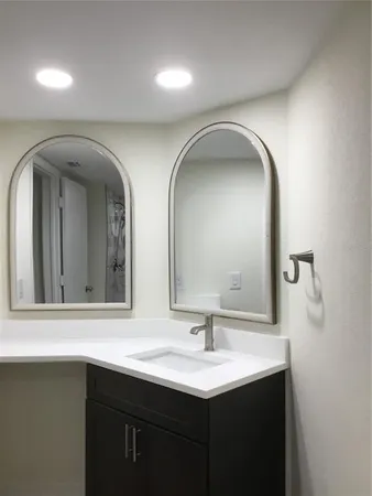 a bathroom with a double vanity sink and a mirror