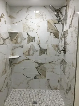a dirty bathroom with white shower