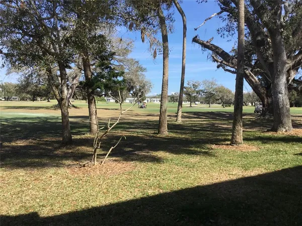 a view of a yard with wooden fence