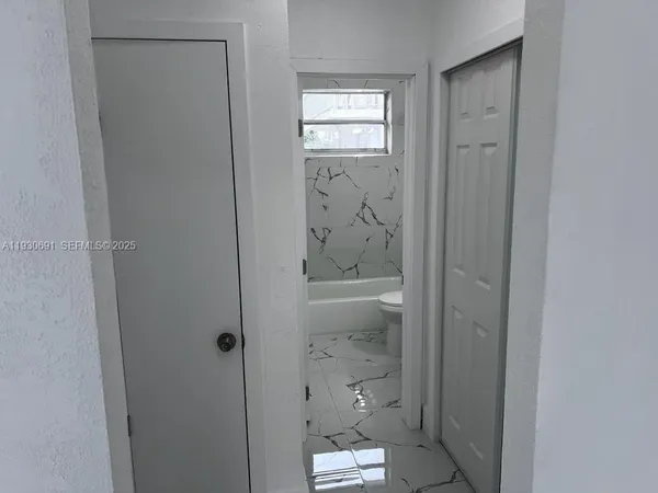a bathroom with a glass shower door