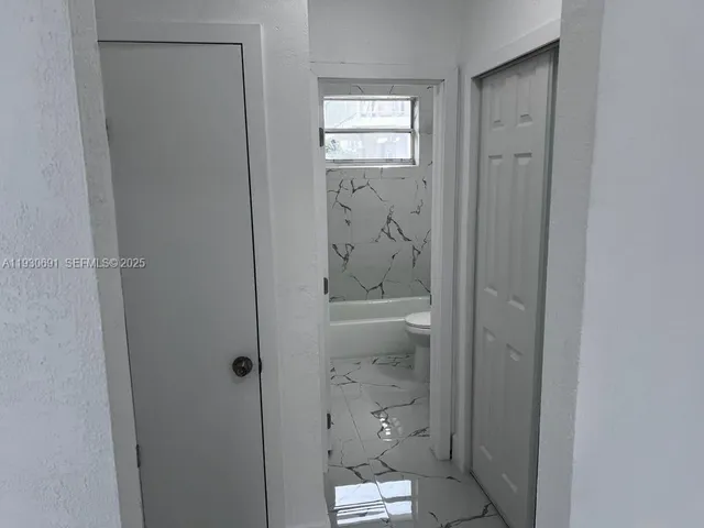 a bathroom with a glass shower door
