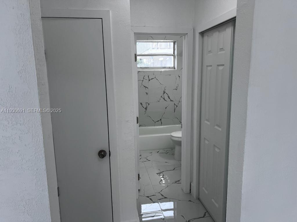 1131 Southwest 7th Street, Unit 3 Miami, FL 33130 - Photo 6 of 7 a bathroom with a glass shower door