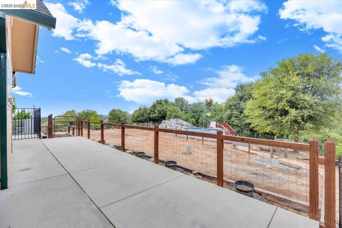 18180 Robin Ridge Road Sonora, CA 95370 - Photo 63 of 88 Spacious concrete patio with wood and wire fencing