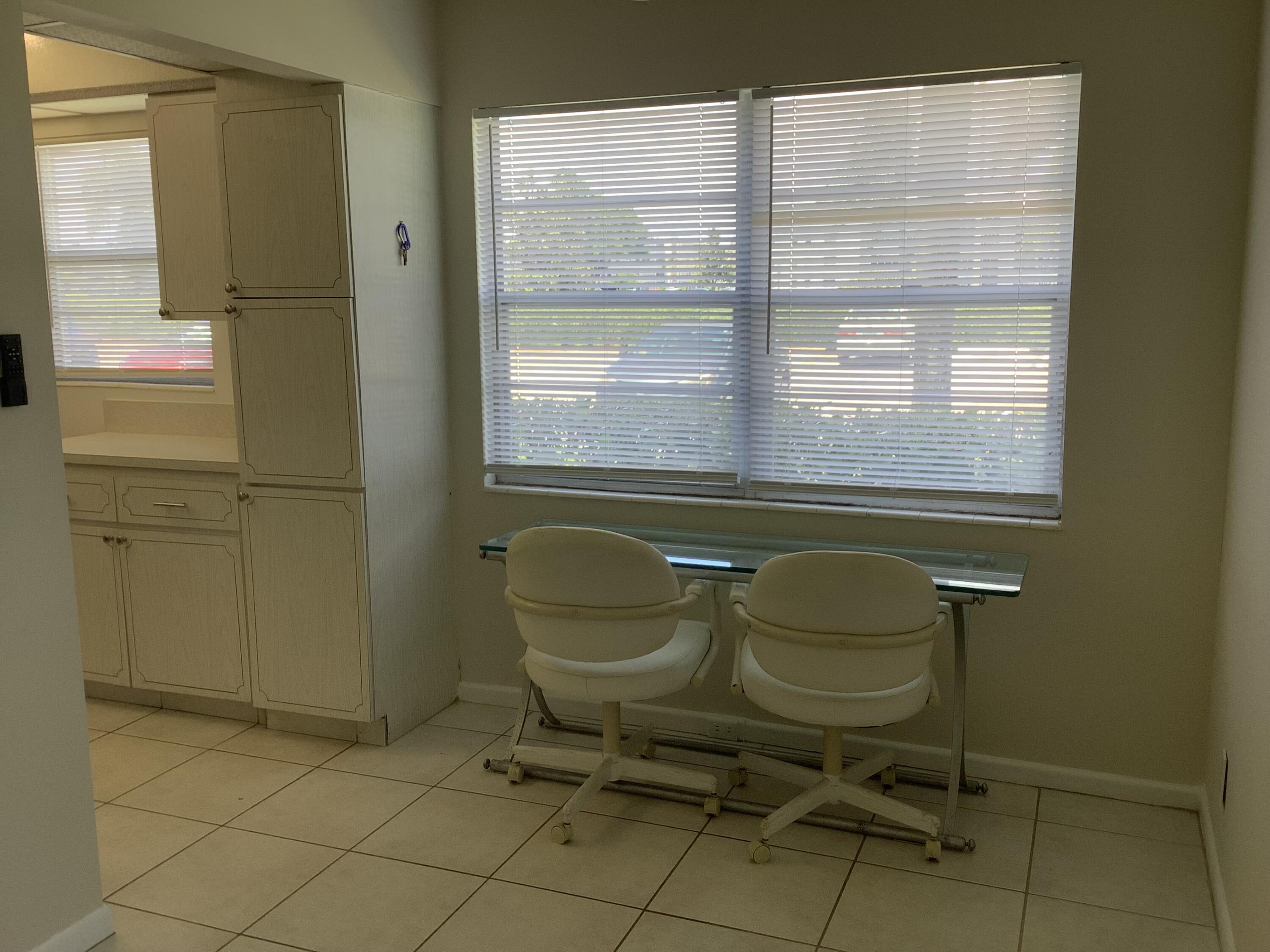 560 Fanshaw North, Unit 560 Boca Raton, FL 33434 - Photo 6 of 26 a bathroom with a sink and a chair