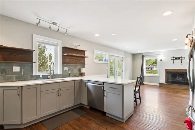 a kitchen with a sink windows and cabinets