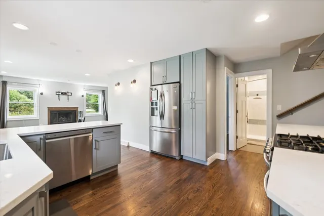 a kitchen with stainless steel appliances a refrigerator and a stove top oven