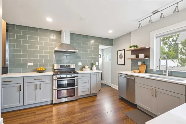 a kitchen with stainless steel appliances granite countertop a stove and a sink