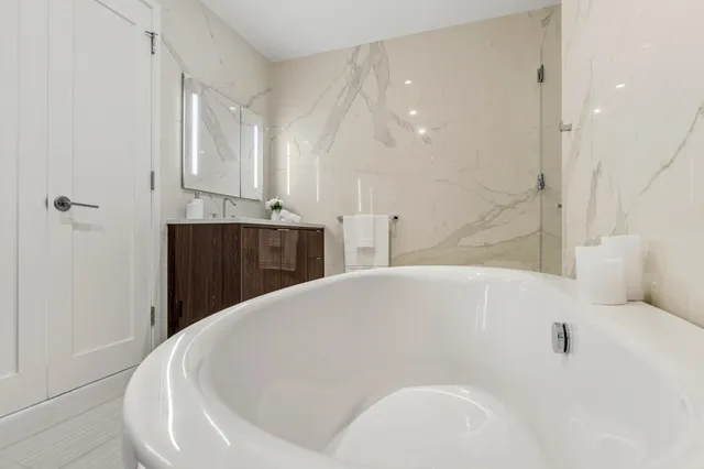 a bathroom with a bathtub and a shower