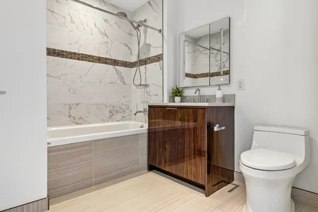 a bathroom with a toilet and a bathtub
