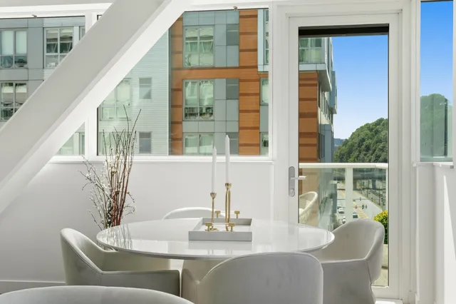 a dining room with furniture and a window