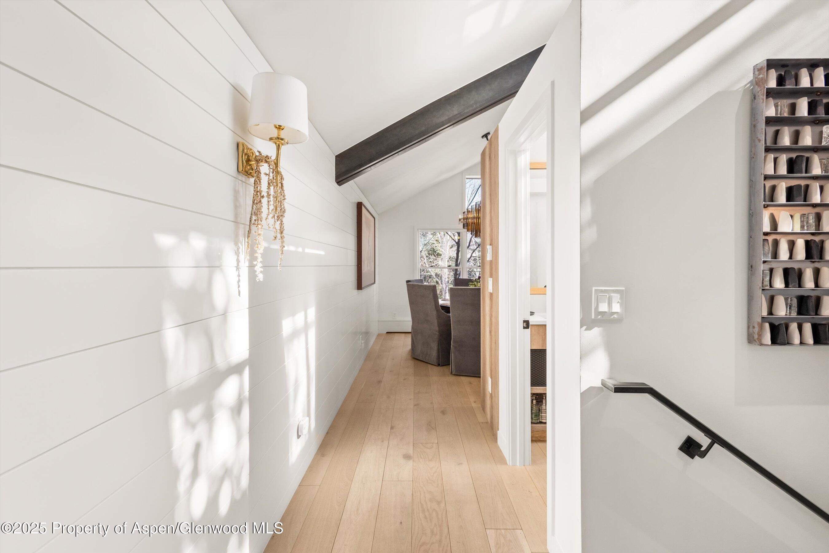929 East Durant Avenue, Unit 4 Aspen, CO 81611 - Photo 16 of 43 a view of a hallway with wooden floor and staircase