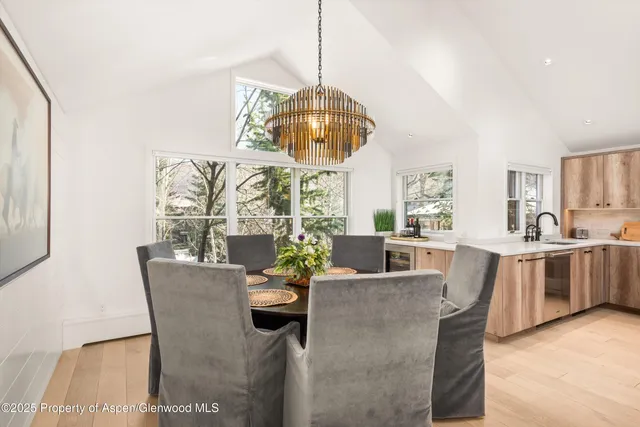 a dining room with furniture a chandelier and a rug