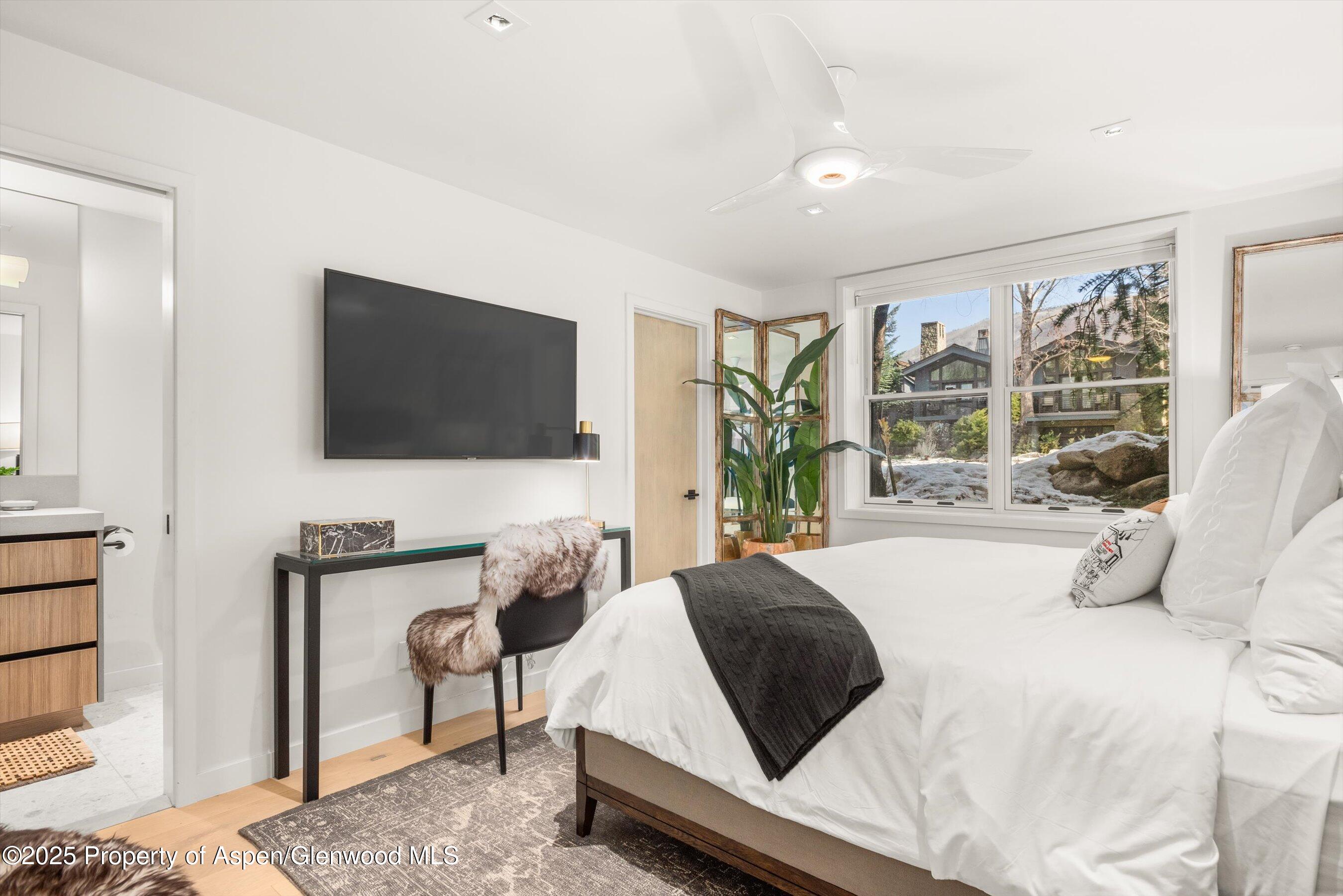 929 East Durant Avenue, Unit 4 Aspen, CO 81611 - Photo 26 of 43 a bedroom with a bed and a flat screen tv