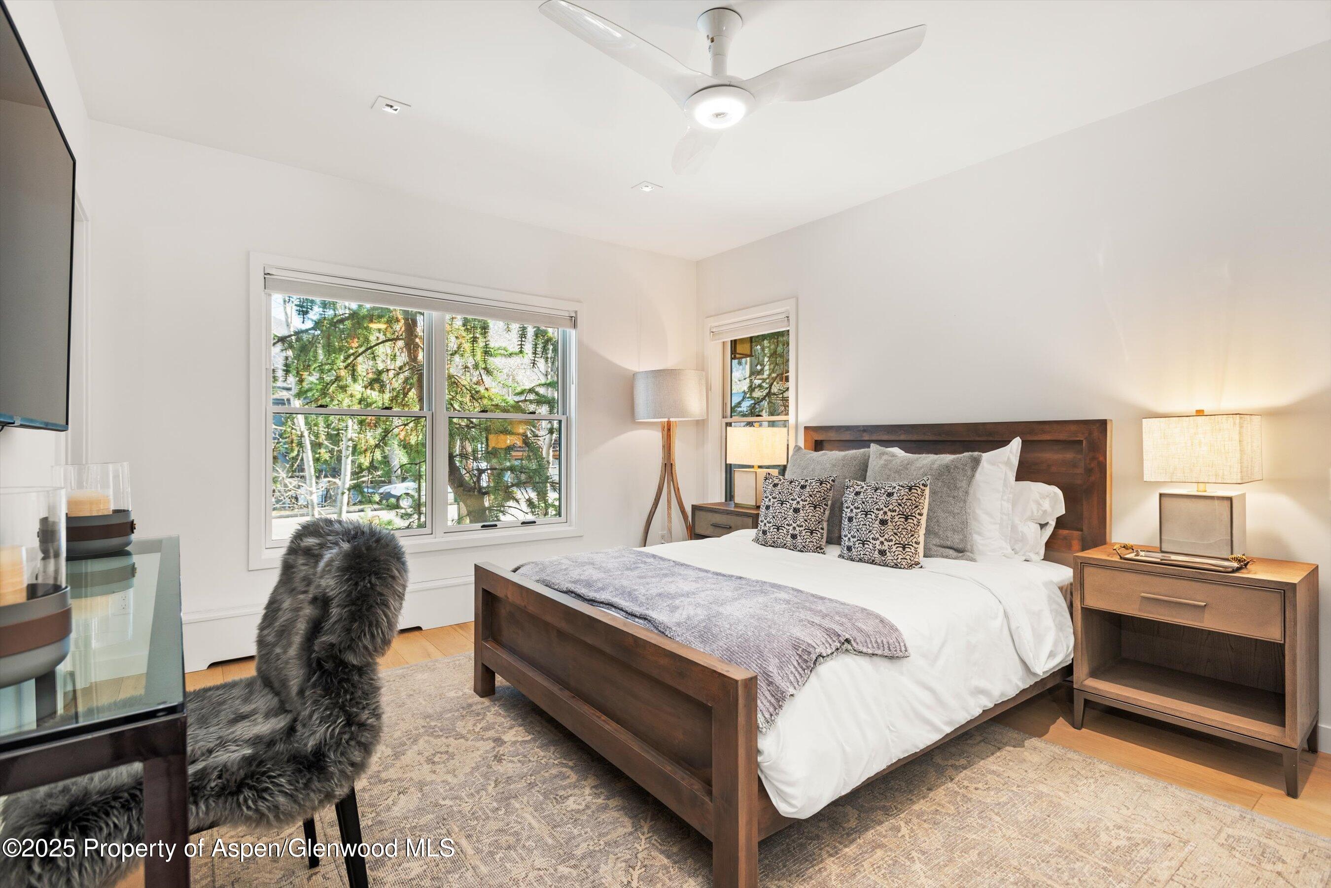 929 East Durant Avenue, Unit 4 Aspen, CO 81611 - Photo 27 of 43 a bedroom with a bed and a chair