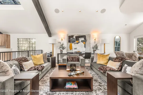 a living room with furniture a rug and a fireplace