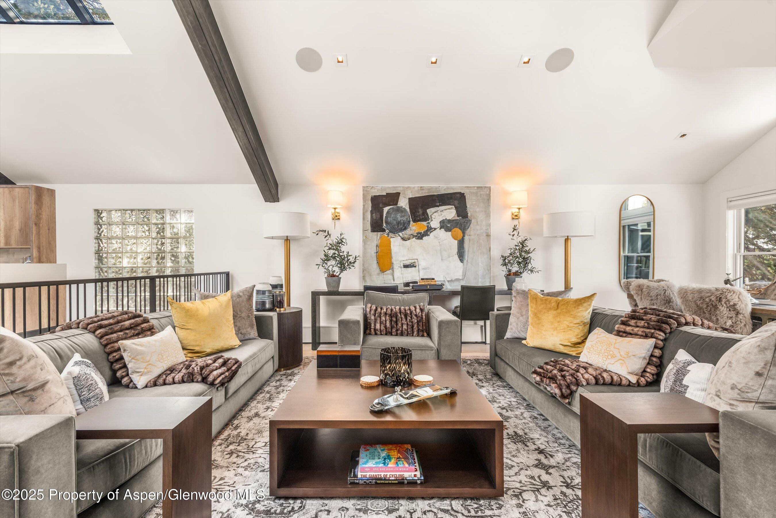 929 East Durant Avenue, Unit 4 Aspen, CO 81611 - Photo 3 of 43 a living room with furniture a rug and a fireplace