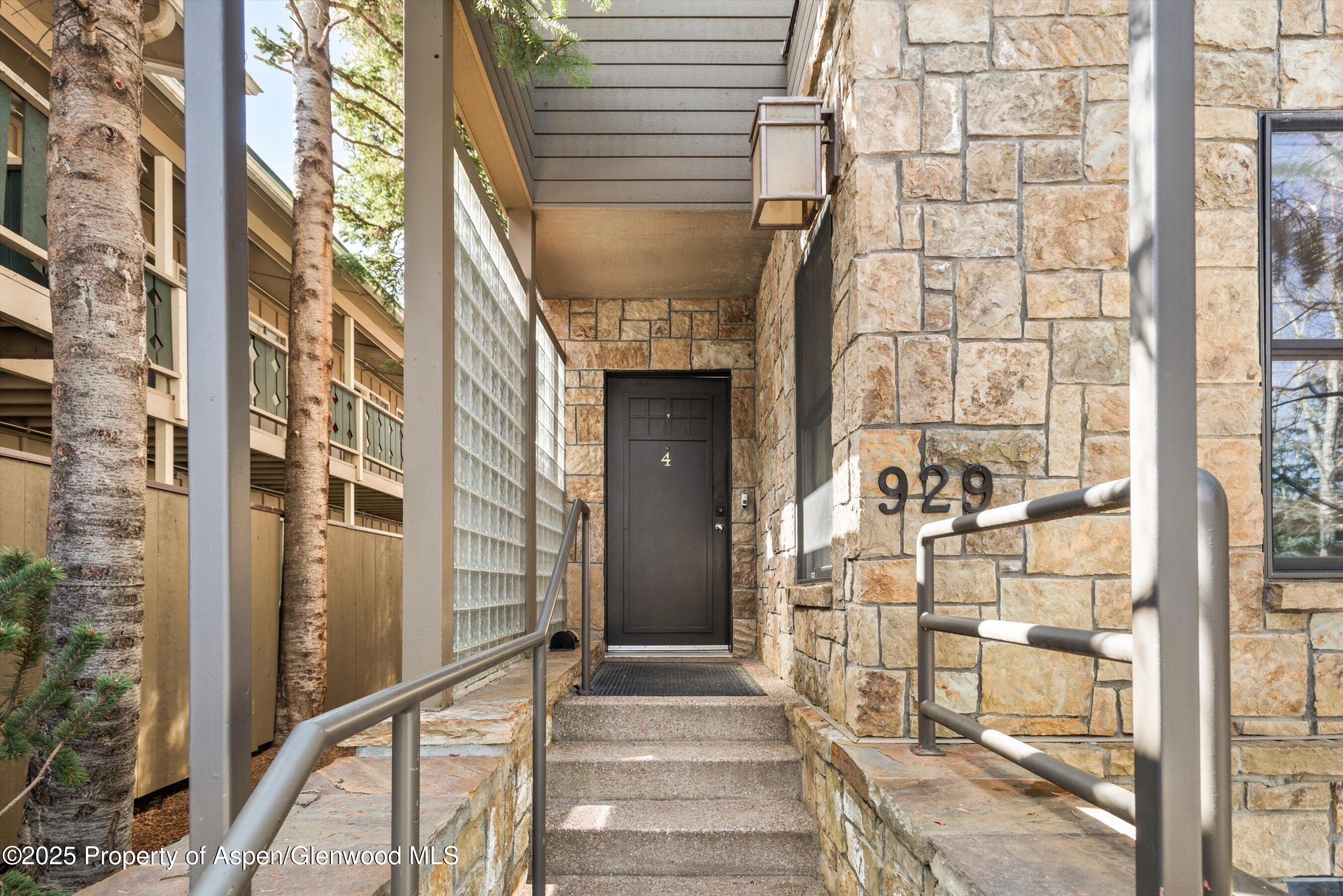 929 East Durant Avenue, Unit 4 Aspen, CO 81611 - Photo 38 of 43 a front view of a building with a glass door