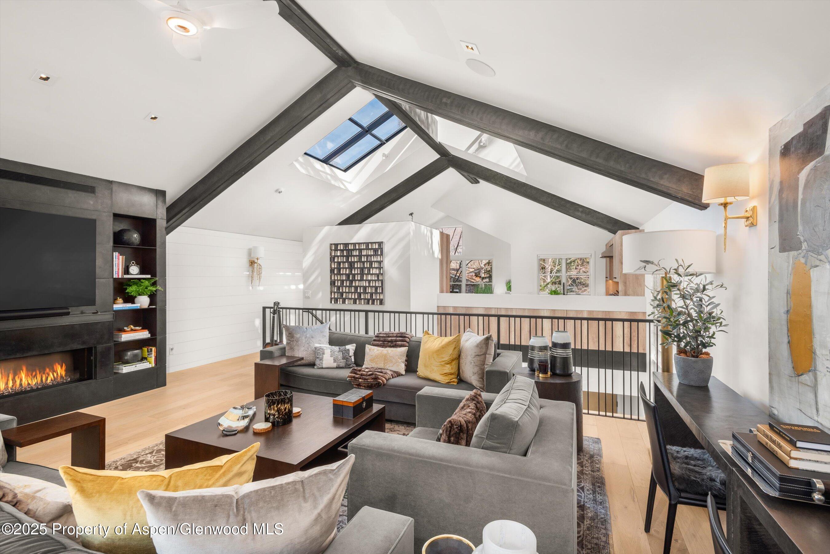 929 East Durant Avenue, Unit 4 Aspen, CO 81611 - Photo 8 of 43 a living room with furniture and a flat screen tv