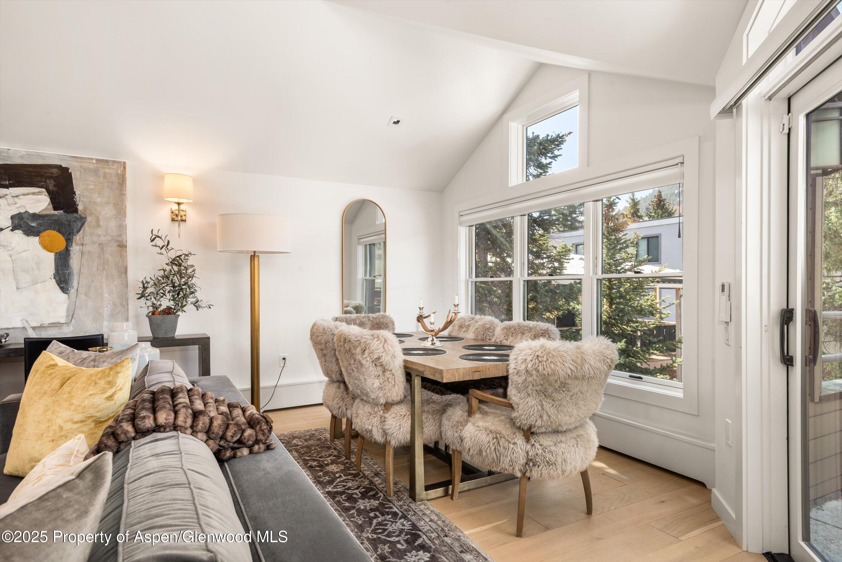 929 East Durant Avenue, Unit 4 Aspen, CO 81611 - Photo 10 of 43 a dining room with furniture a rug and a large window