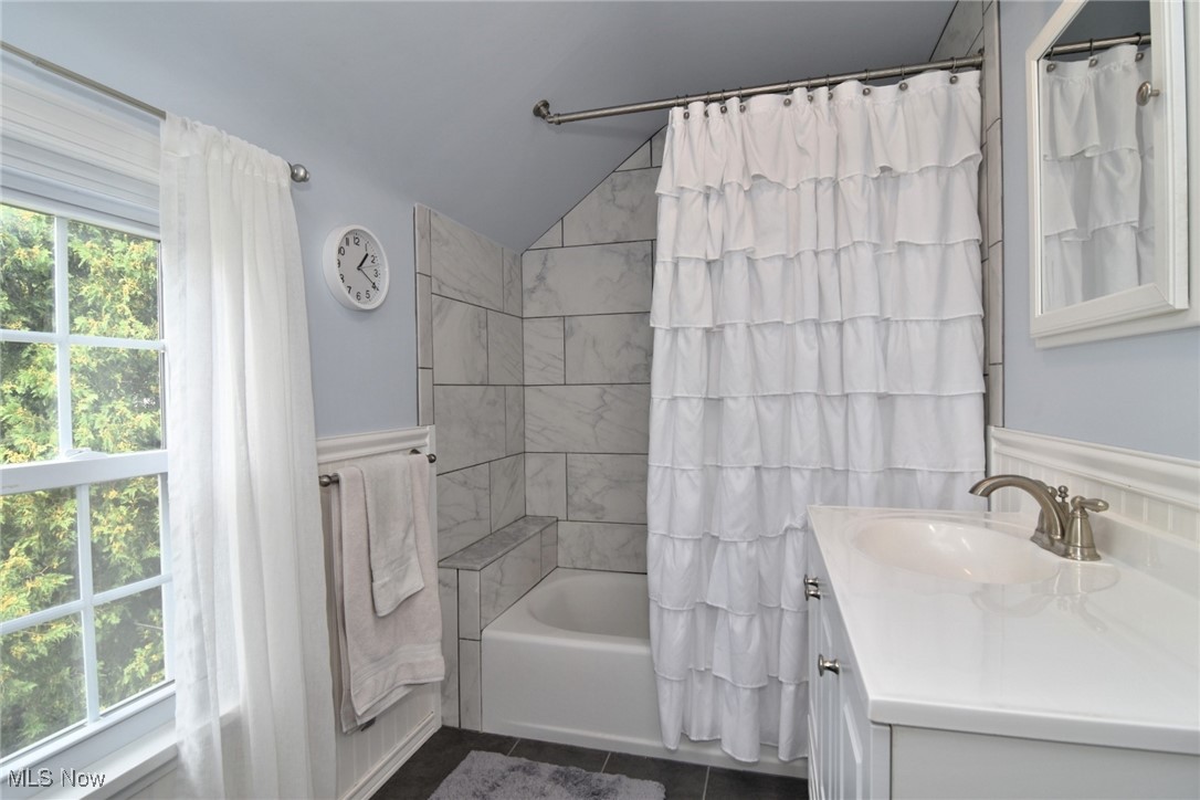 2278 Traymore Road Cleveland, OH 44118 - Photo 32 of 49 Full bath with vanity, shower / bath combination with curtain, lofted ceiling, and dark tile patterned flooring