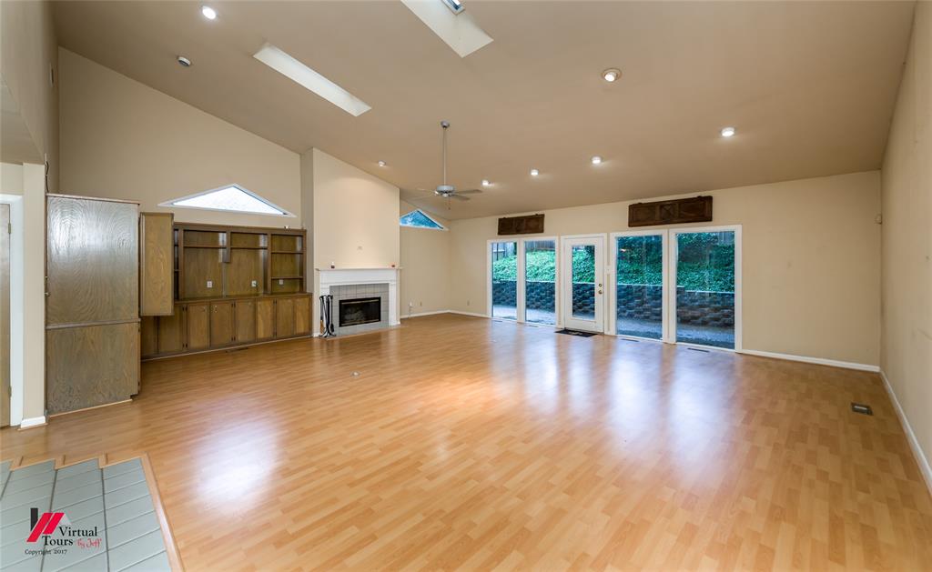 300 Pierremont Road, Unit 40 Shreveport, LA 71106 - Photo 23 of 34 Spacious living area featuring LVF flooring, vaulted ceilings, and skylights and overlooks a open back patio