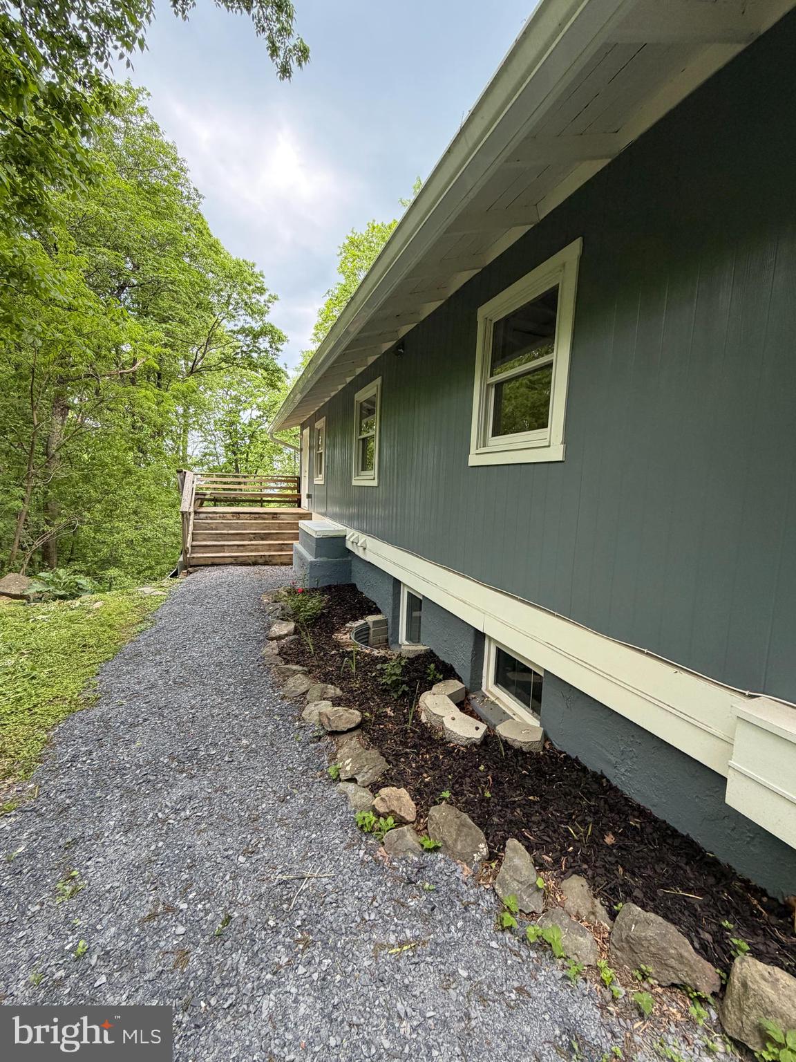 146 Trillium Trail Road Linden, VA 22642 - Photo 2 of 21 a backyard of a house with wooden fence and large trees