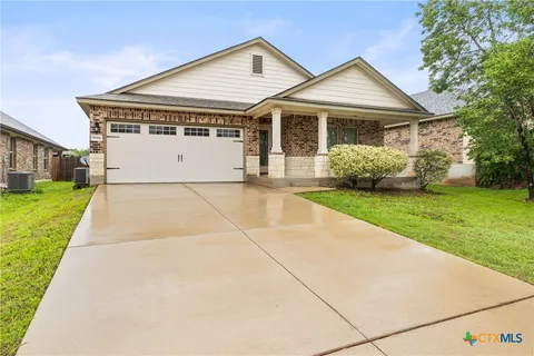 a view of house that has a yard