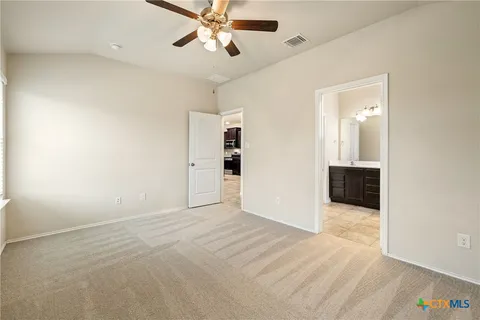 an empty room with fan and entrance