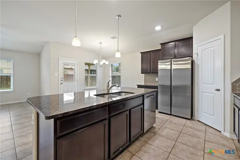 a view of a kitchen with furniture and a kitchen view