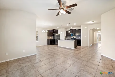 a kitchen with stainless steel appliances granite countertop a stove a sink and a refrigerator