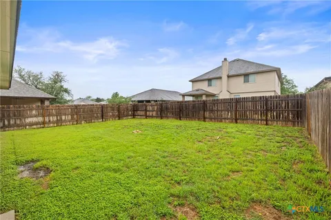 a front view of a house with yard and green space