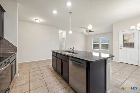 a kitchen with stainless steel appliances granite countertop a sink and a stove