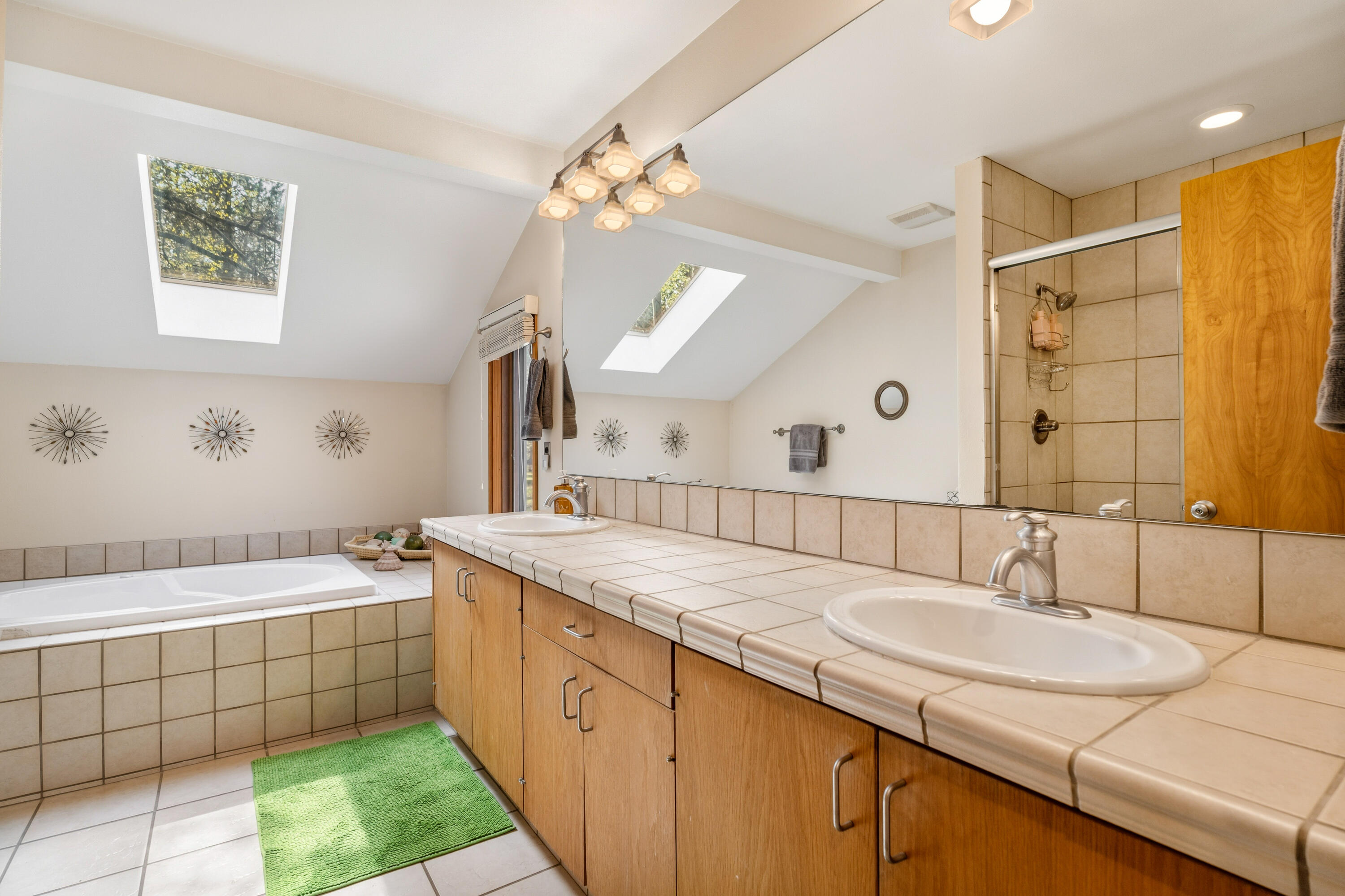 17866 Grouse Lane, Unit 3 Sunriver, OR 97707 - Photo 40 of 61 a bathroom with a granite countertop sink a large mirror and a bathtub