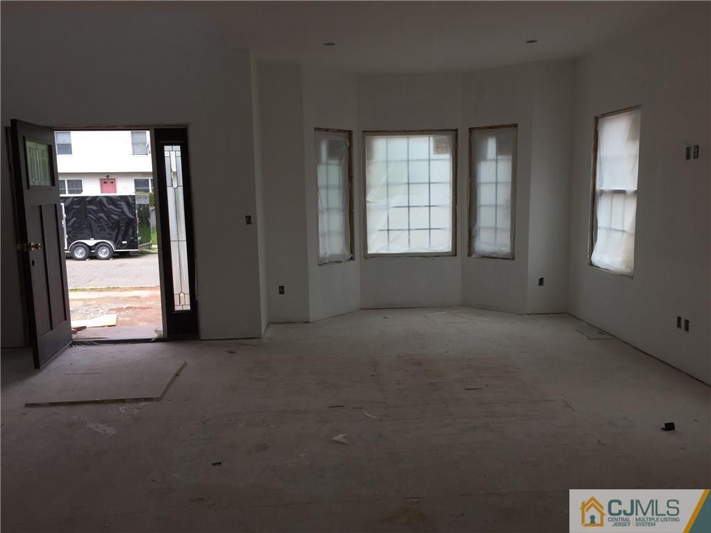 162 Larch Street Port Reading, NJ 07064 - Photo 2 of 9 an empty room with windows