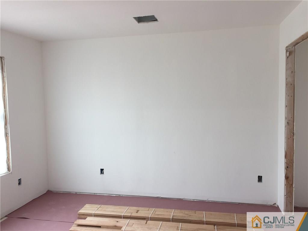162 Larch Street Port Reading, NJ 07064 - Photo 8 of 9 a view of room with hardwood floor and window